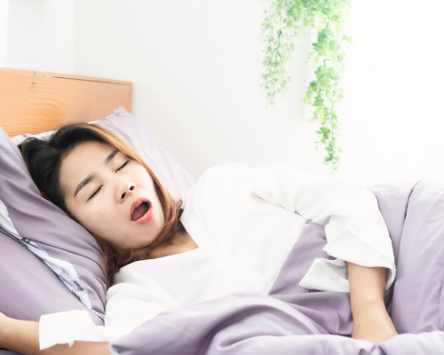 Young Asian women sleeping with her mouth open, portraying info on nighttime dry mouth